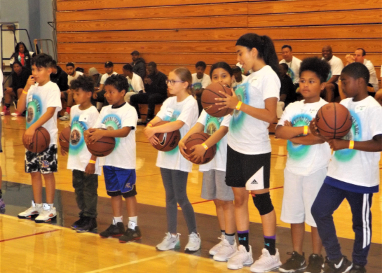 Junior Deputy Program participants learn basketball skills at Go Beyond the Arc clinics.